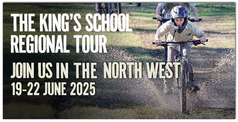 Tudor House student riding his bike through mud towards the camera