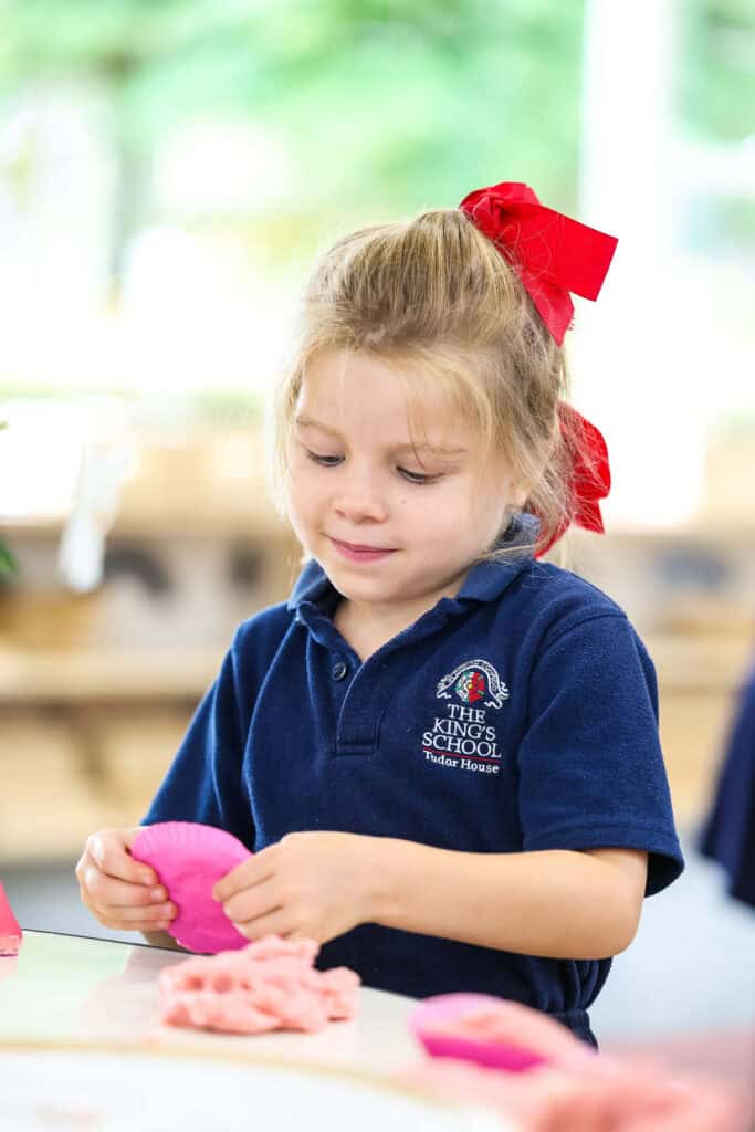 Tudor House pre-kindergarten student in a classroom using play dough