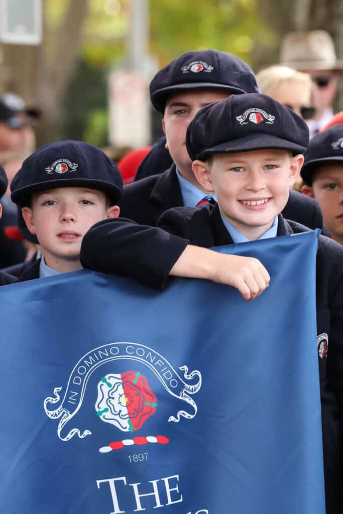 Tudor House students holding a banner at a parade